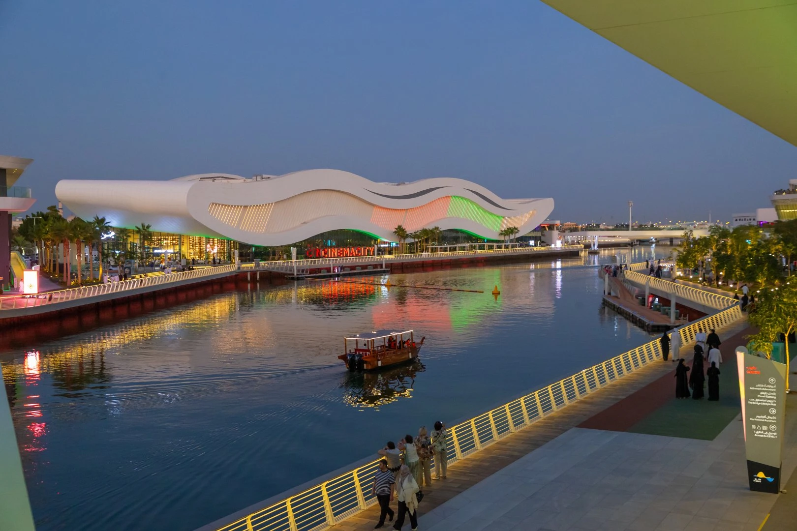 Al Qana waterfront at dusk, Abu Dhabi, with colorful building lights.