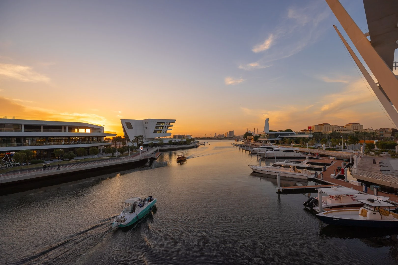 Sunset view of Al Qana waterfront, Abu Dhabi with boats.
