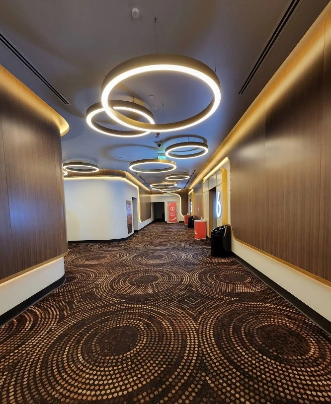 Modern hallway with circular lights at AMC Cinemas Ajdan Walk Al Khobar.