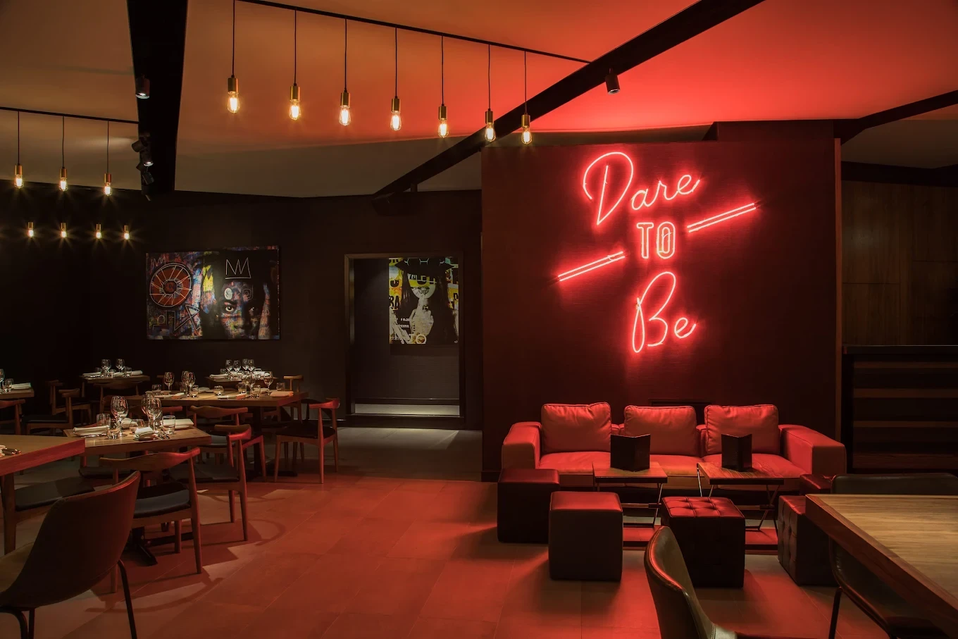 STK Dubai JBR lounge with neon sign 'Dare to Be'.