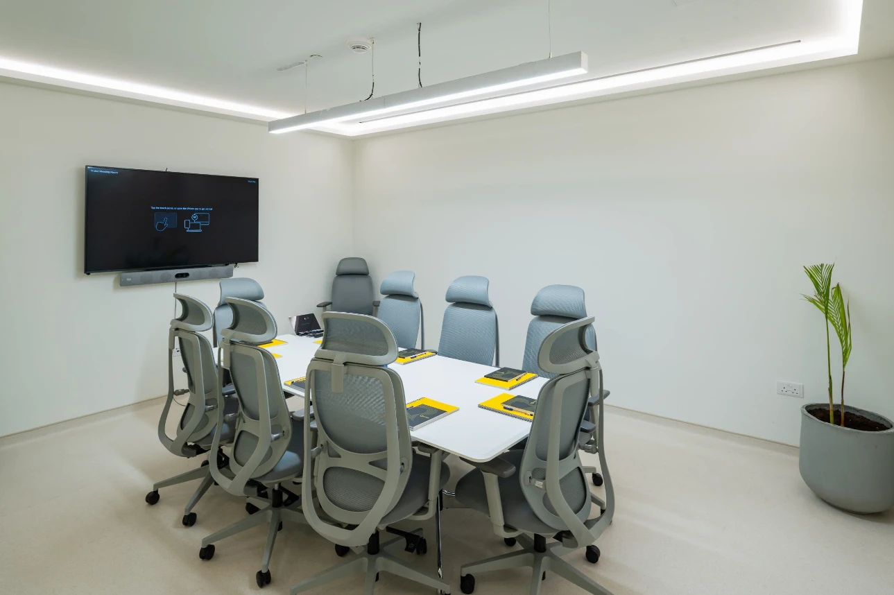 Conference room with gray chairs and screen, Expo City Dubai.