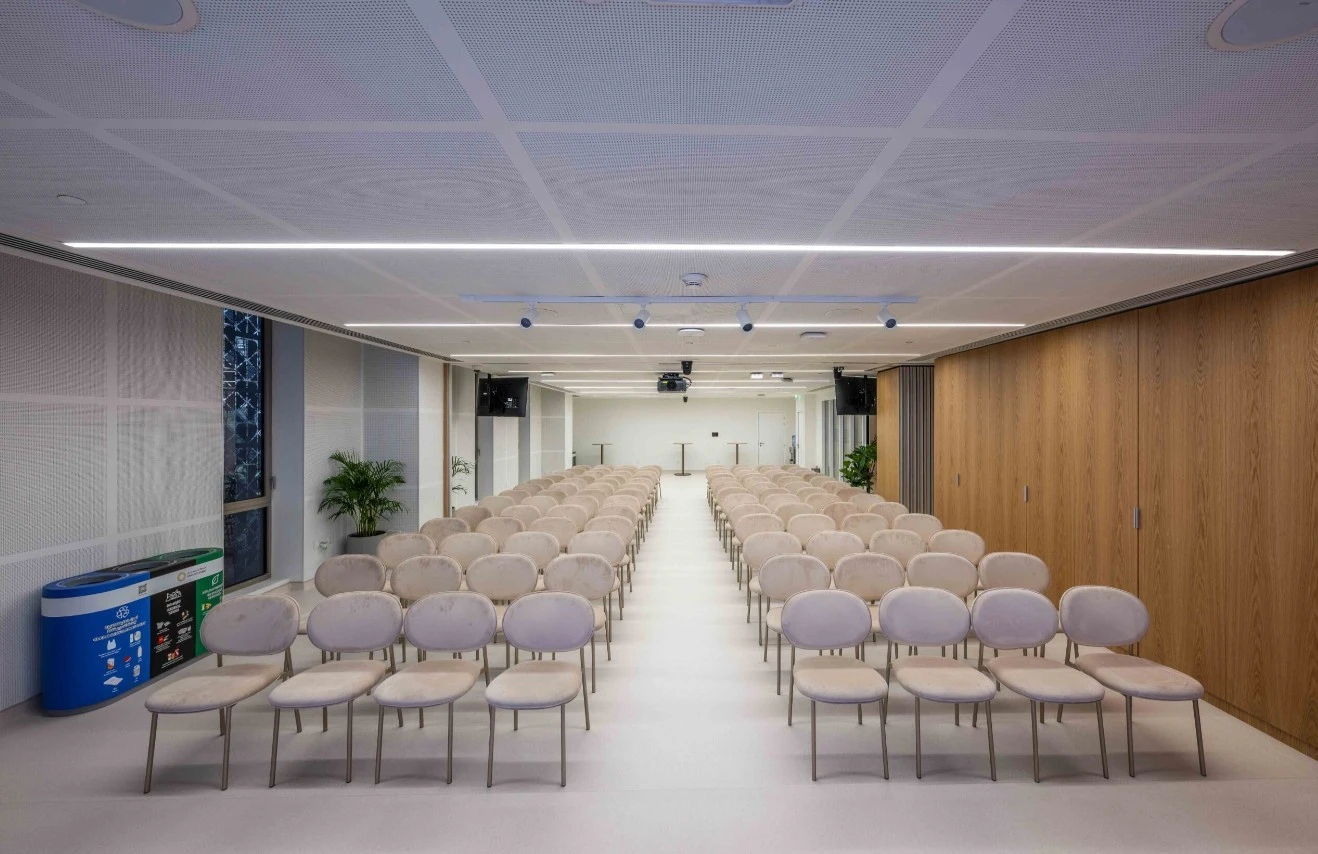 Expo City Dubai multi-purpose hall with rows of beige chairs.