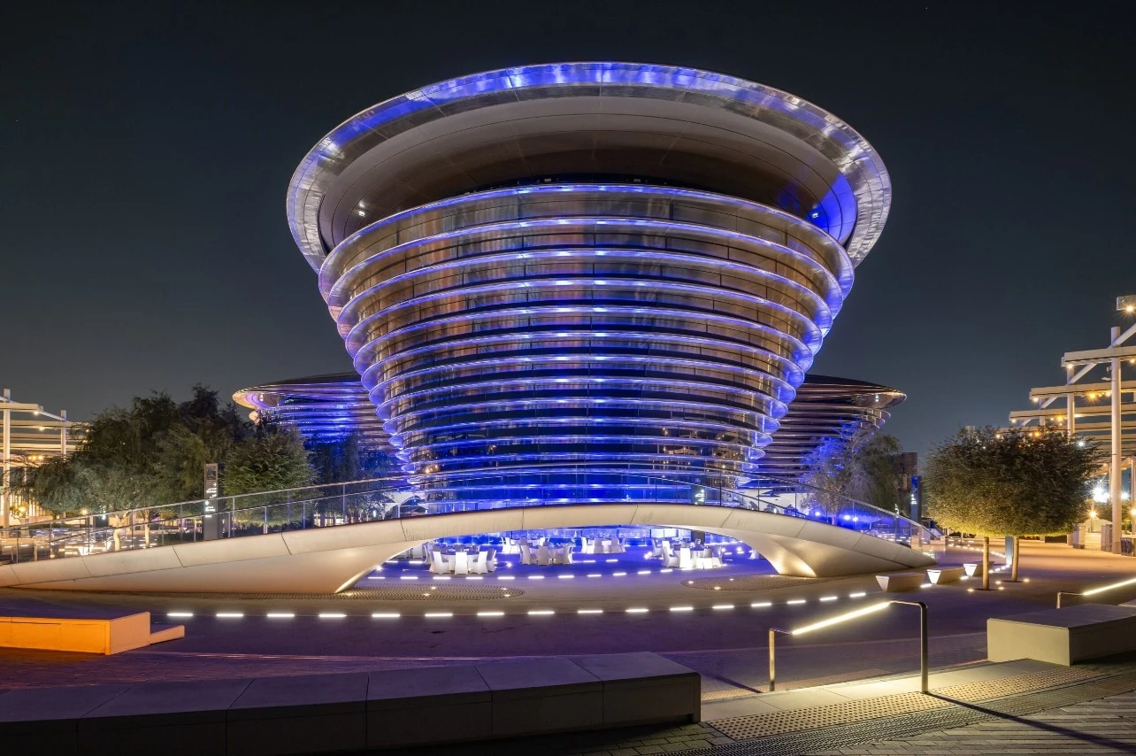 Expo City Dubai illuminated at night with futuristic architecture.