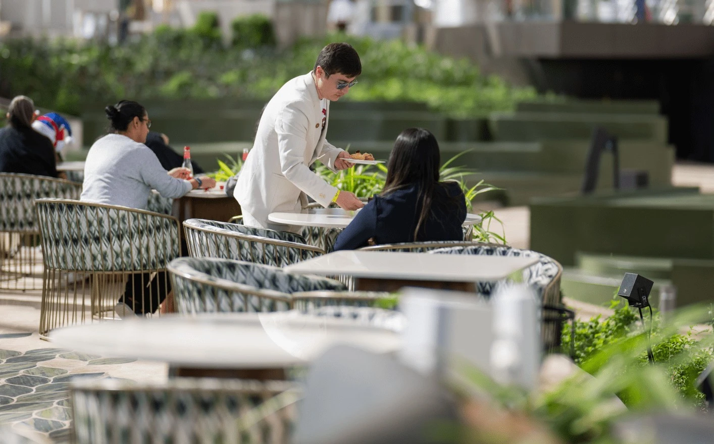Waiter serving guests at Al Wasl Cafe, Expo City Dubai.