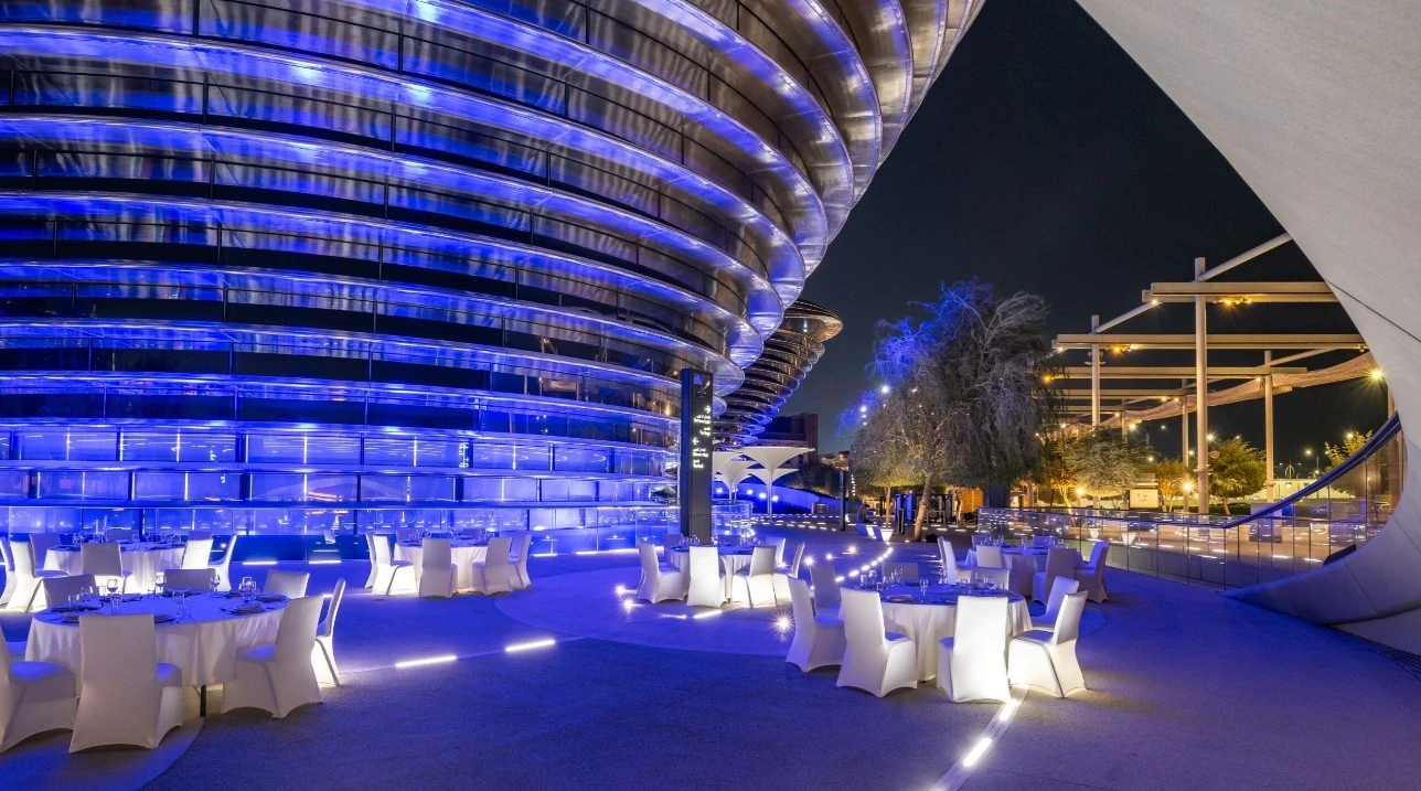 Expo City Dubai outdoor venue with blue lighting at night.