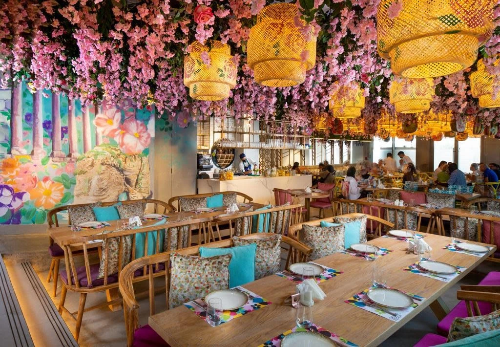 Colorful restaurant with floral decor at Expo City Dubai.