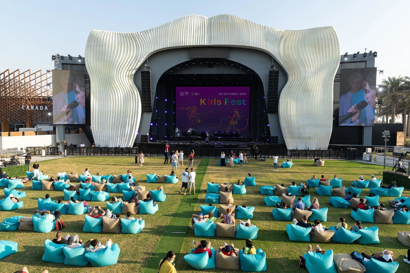 Jubilee Park stage at Expo City Dubai with audience seated outdoors.