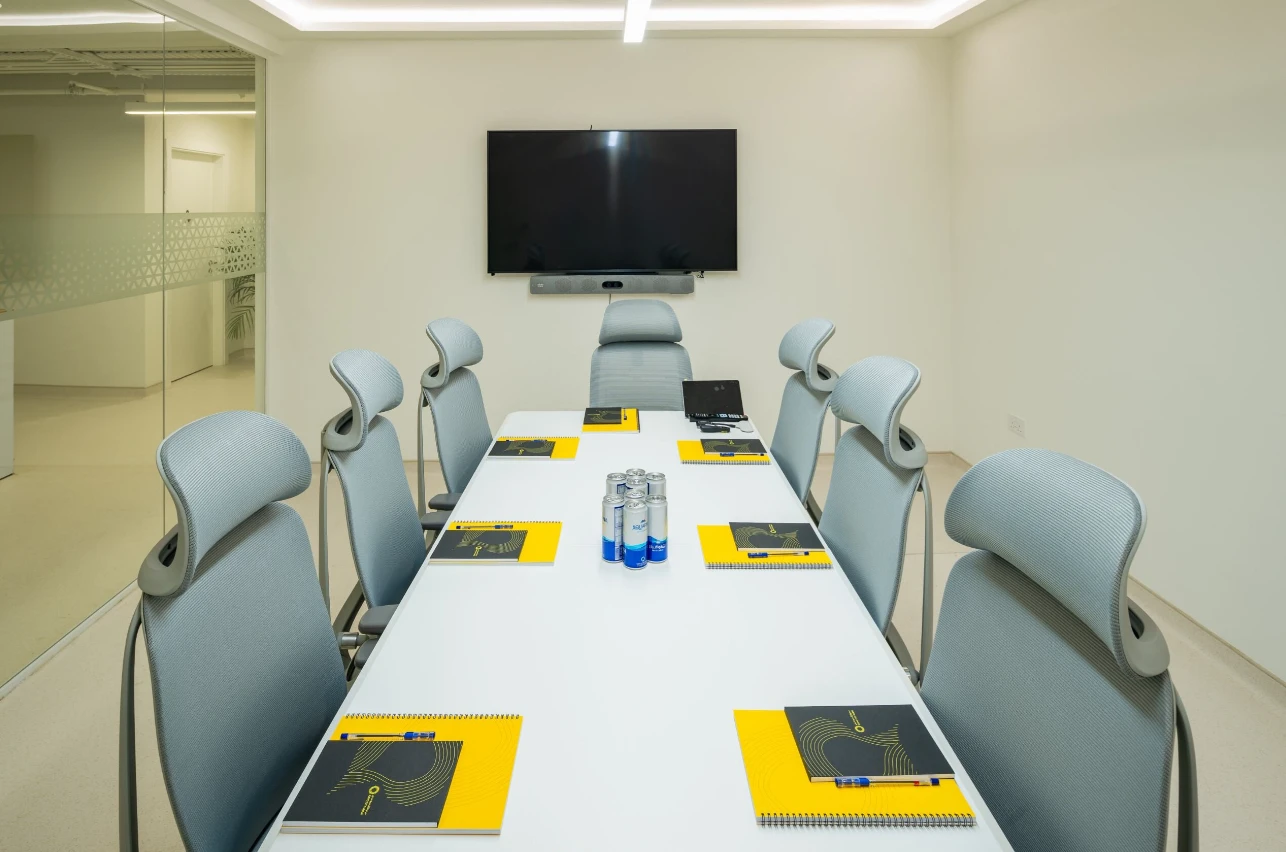 Modern conference room at Expo City Dubai with chairs and screen.