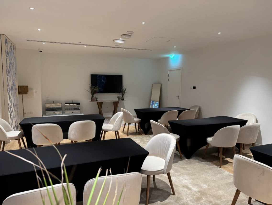 Modern conference room at Expo City Dubai with black tablecloths.