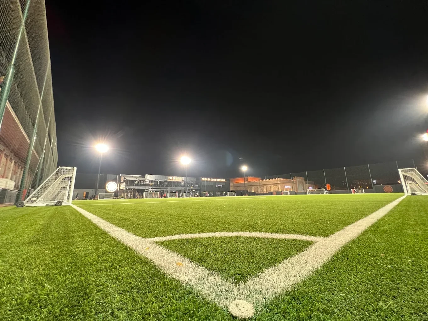 Precision Football field at night, illuminated in Dubai.