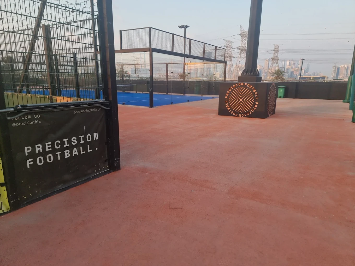 Precision Football outdoor court with city skyline, Dubai.