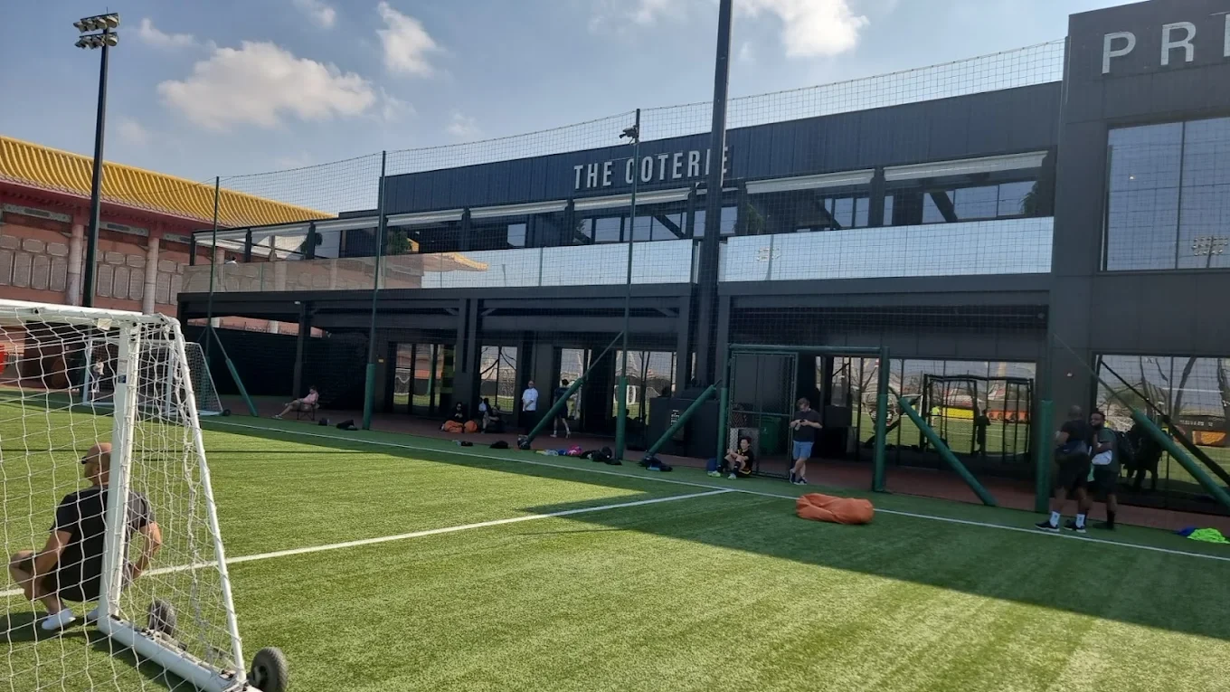 Precision Football field with players, Dubai, sunny day
