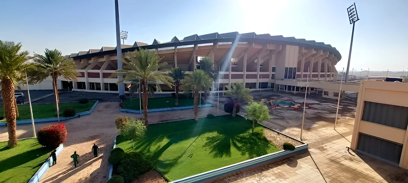 King Khalid Sport City Stadium exterior with palm trees, Tabuk.