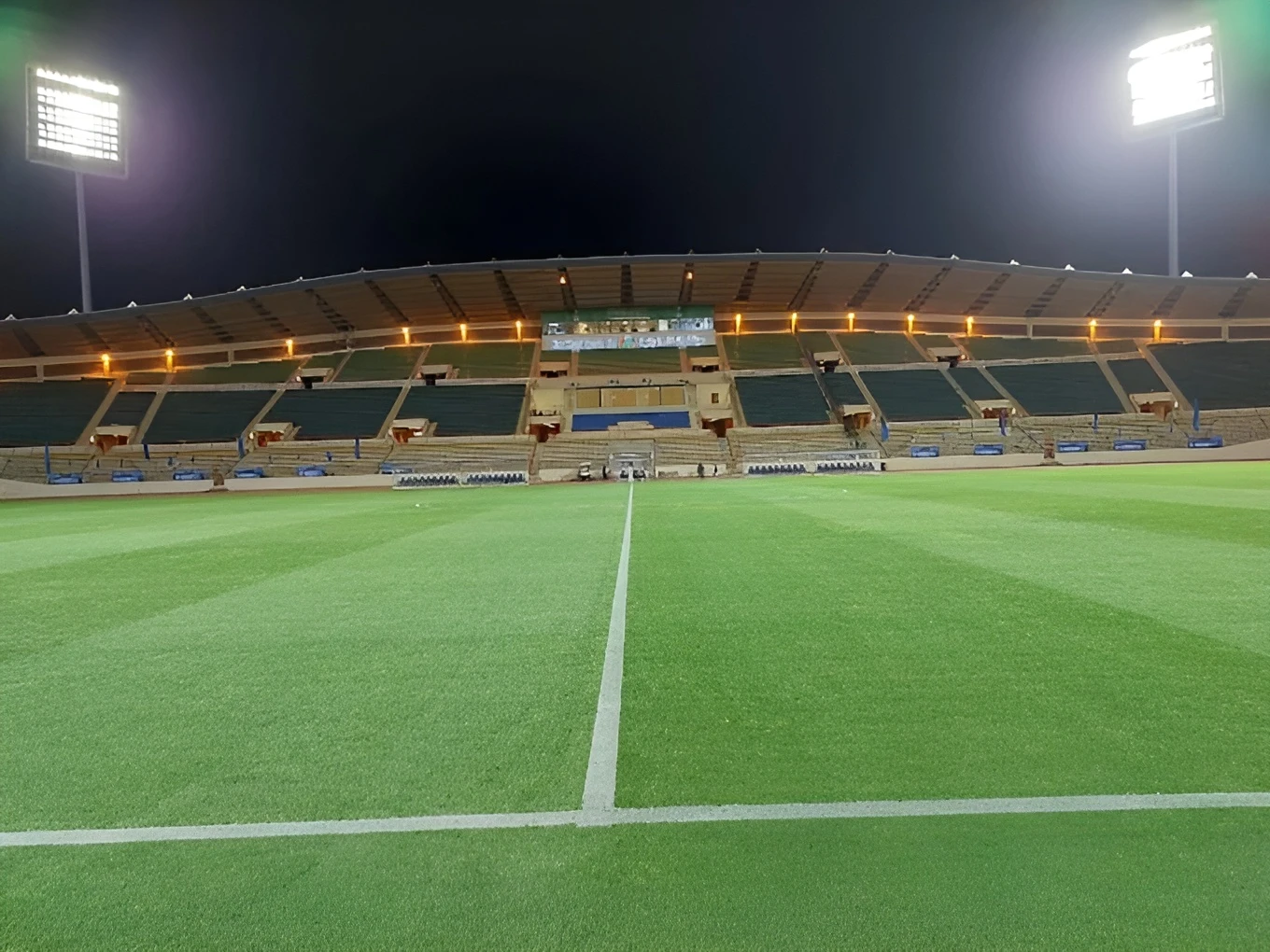 King Khalid Sport City Stadium in Tabuk at night, empty stands.