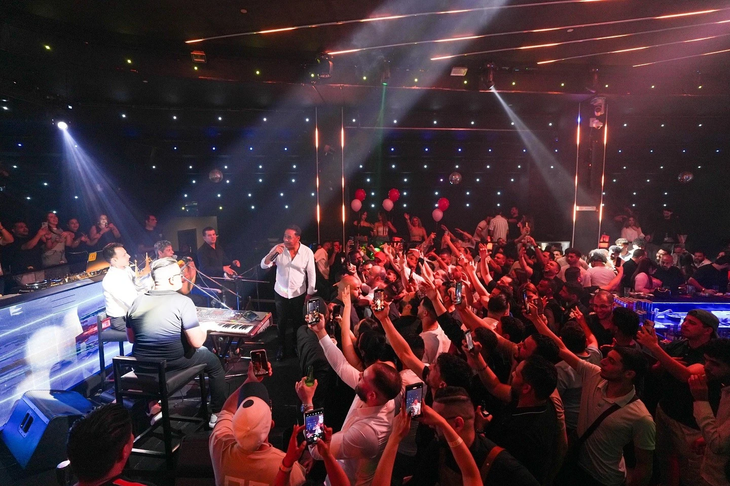 Live performance at OX Club Doha with enthusiastic crowd.