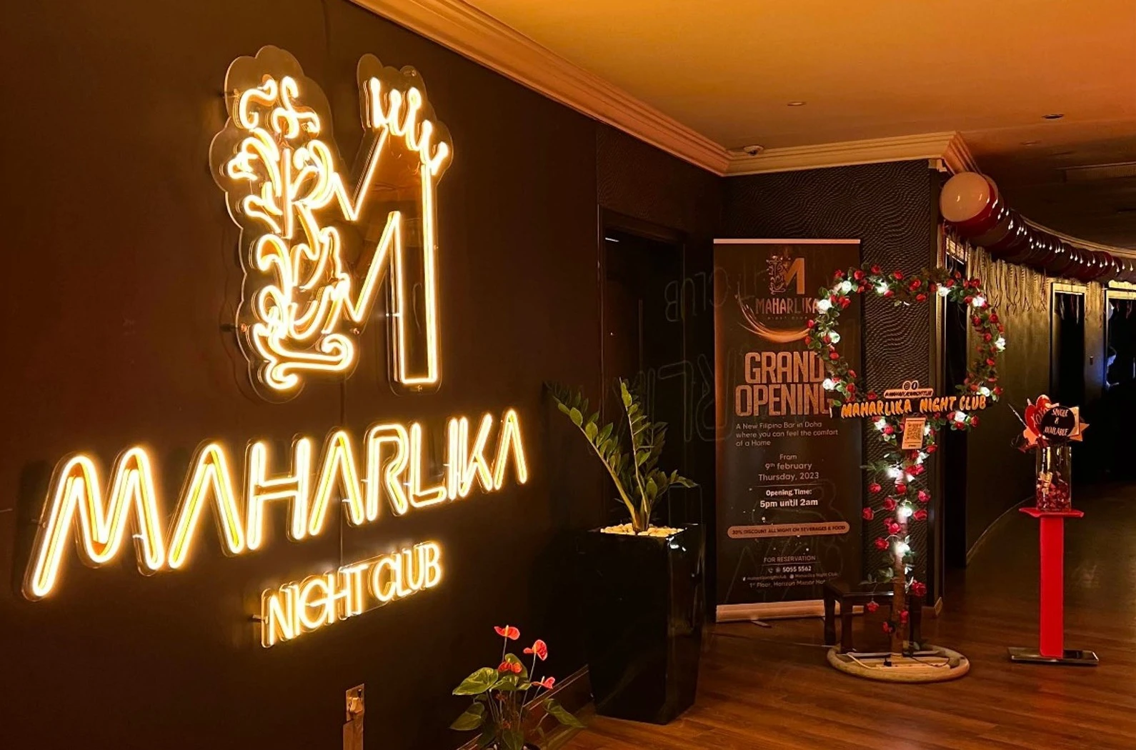 Maharlika Night Club Doha entrance with neon sign and decorations.