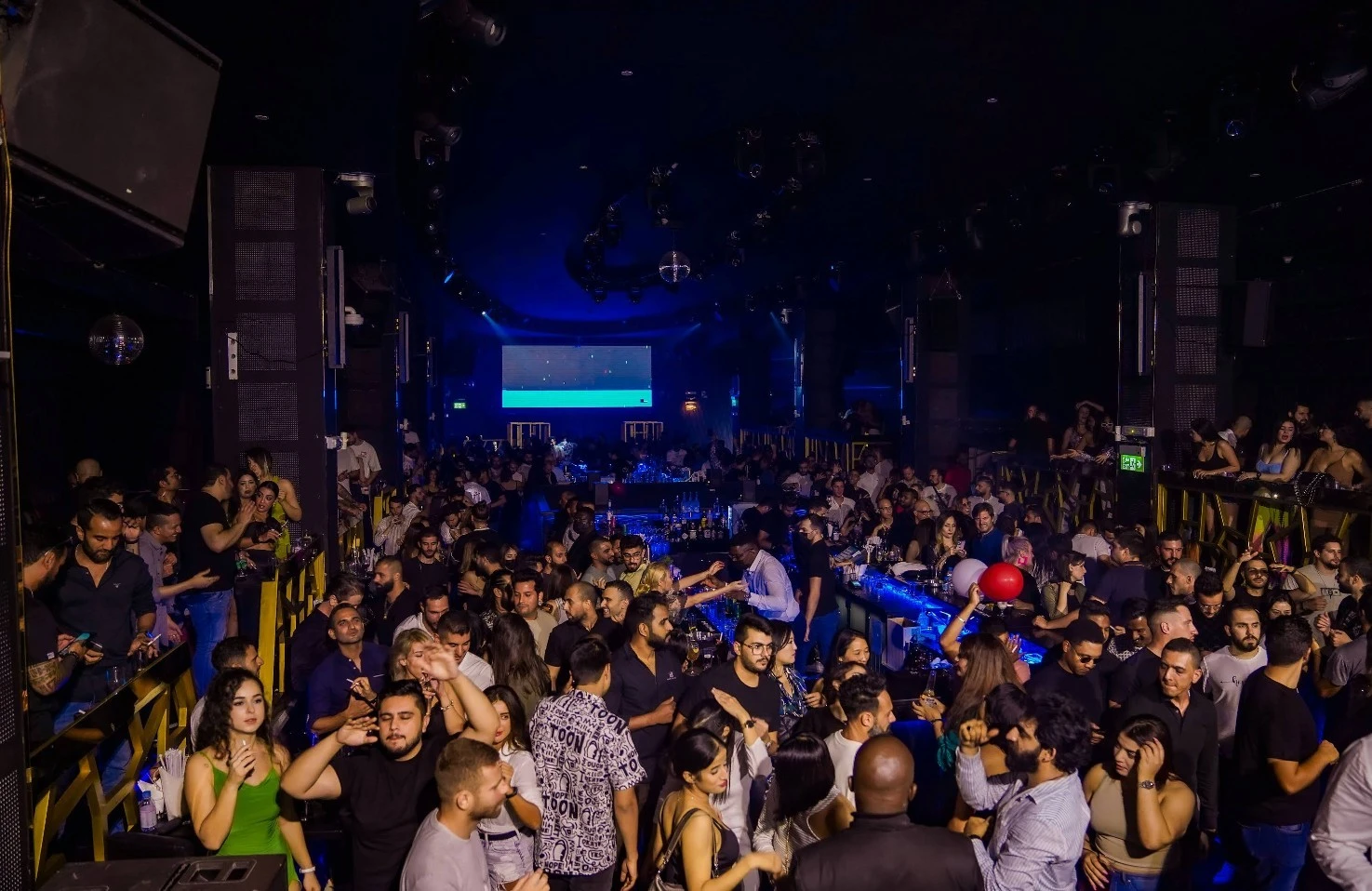 Crowded nightclub scene at OX Club Doha with lively atmosphere.