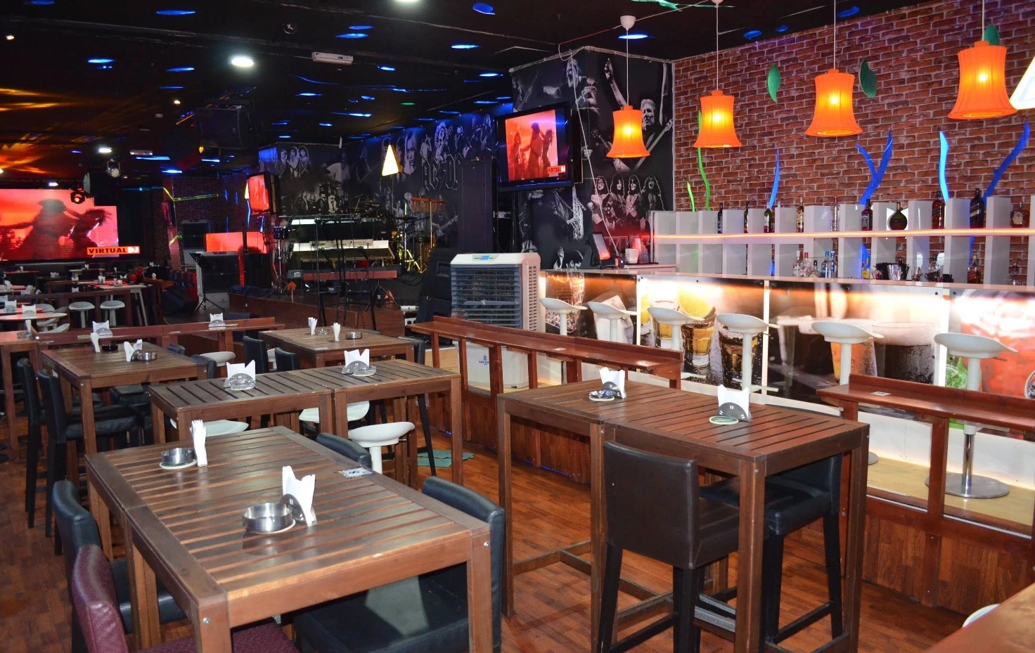 Krossroads Club Doha interior with tables, bar, and stage area.