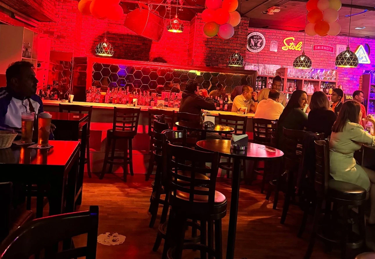 Krossroads Club Doha interior with patrons and red lighting.