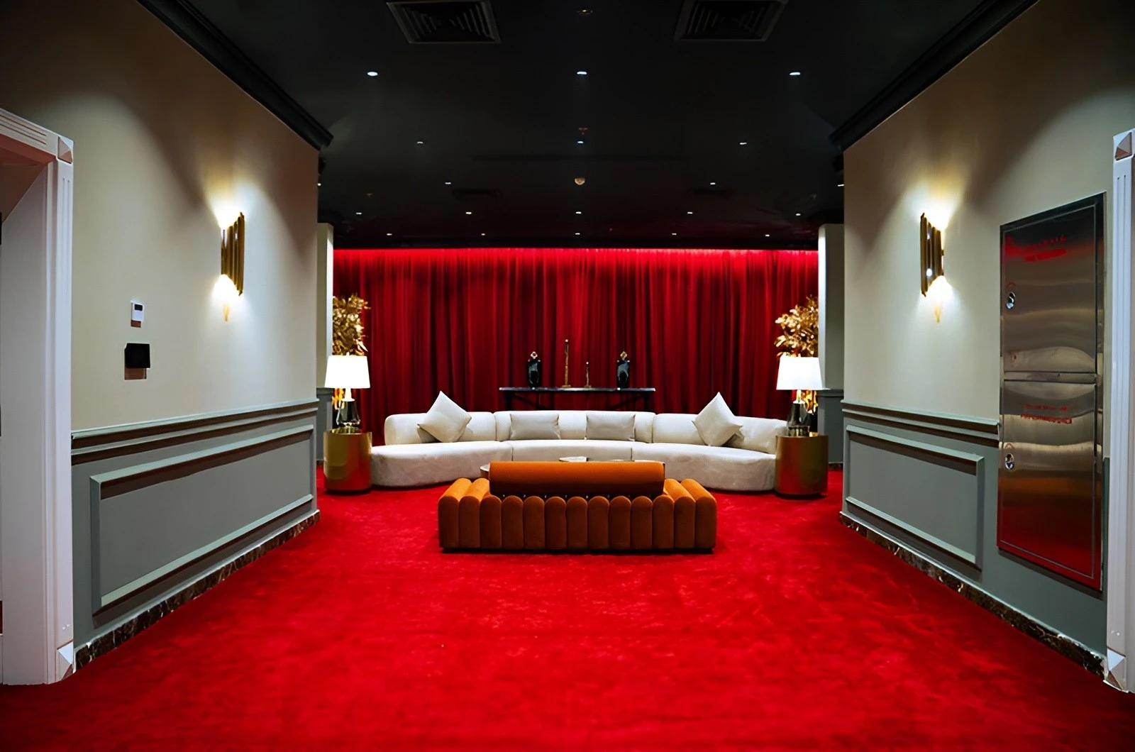 Luxurious lounge at U Venue Doha with red carpet and sofas.