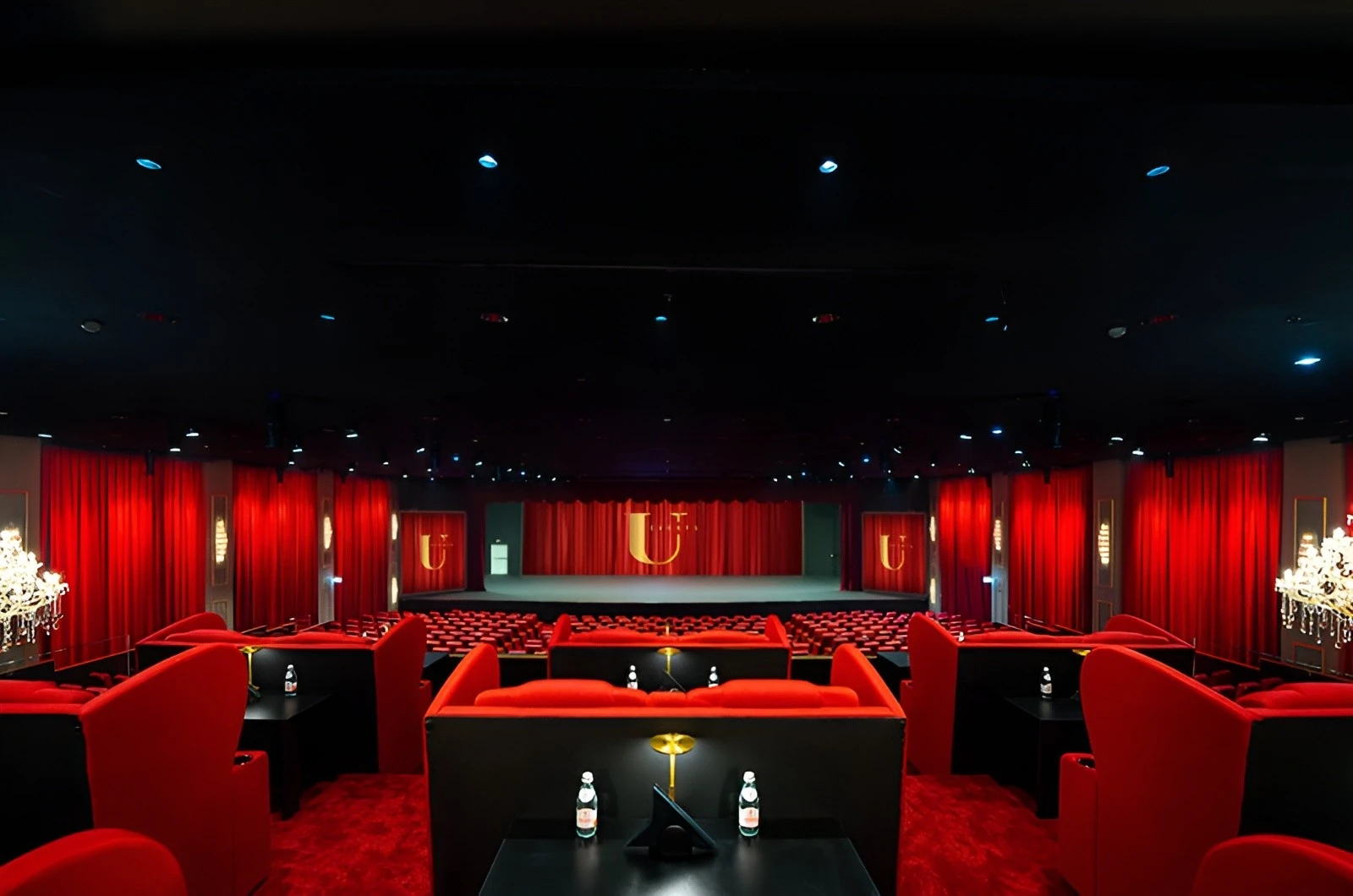 Luxurious red seating and stage at U Venue Doha.