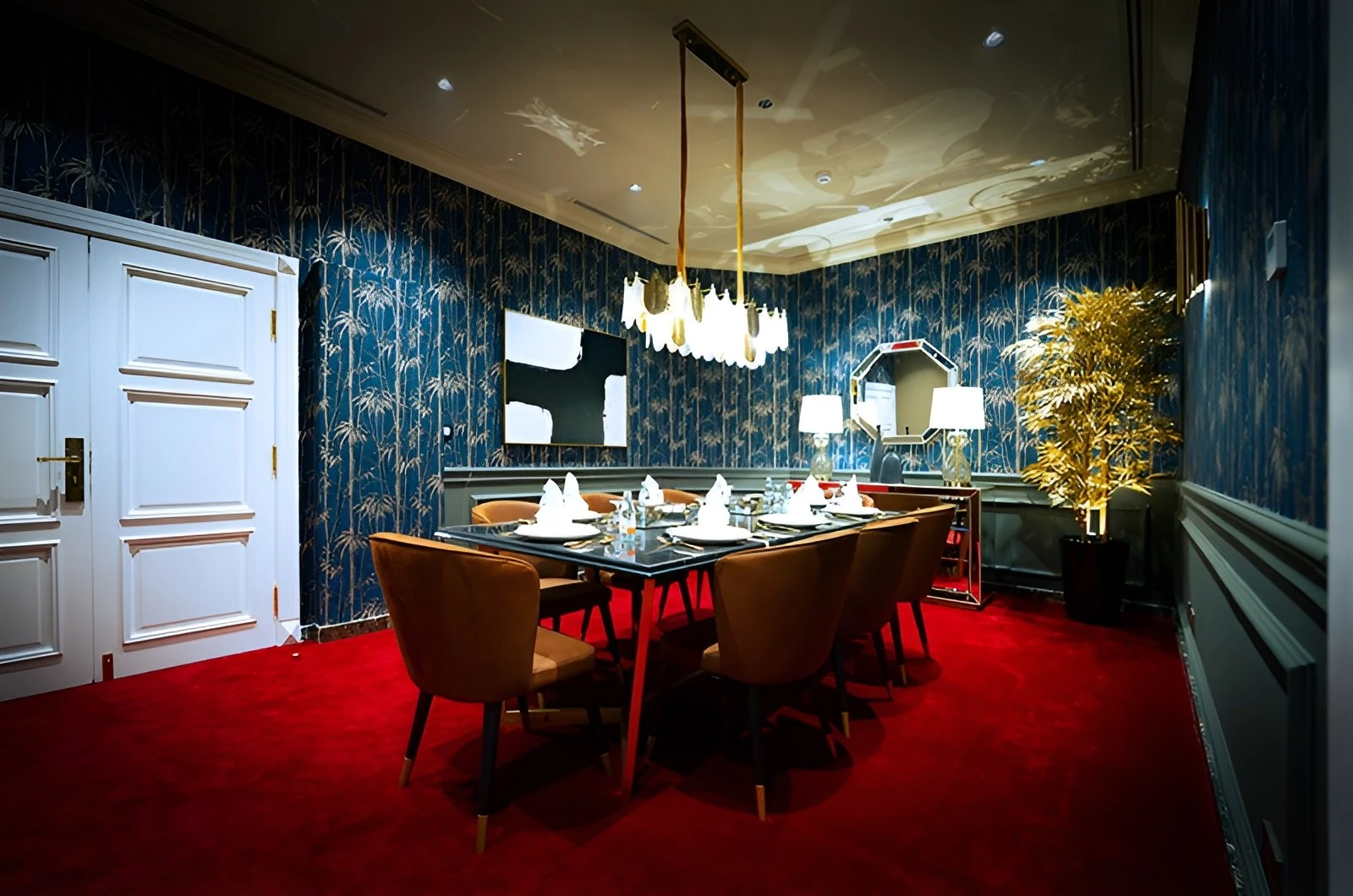 Elegant dining room at U Venue Doha with red carpet.