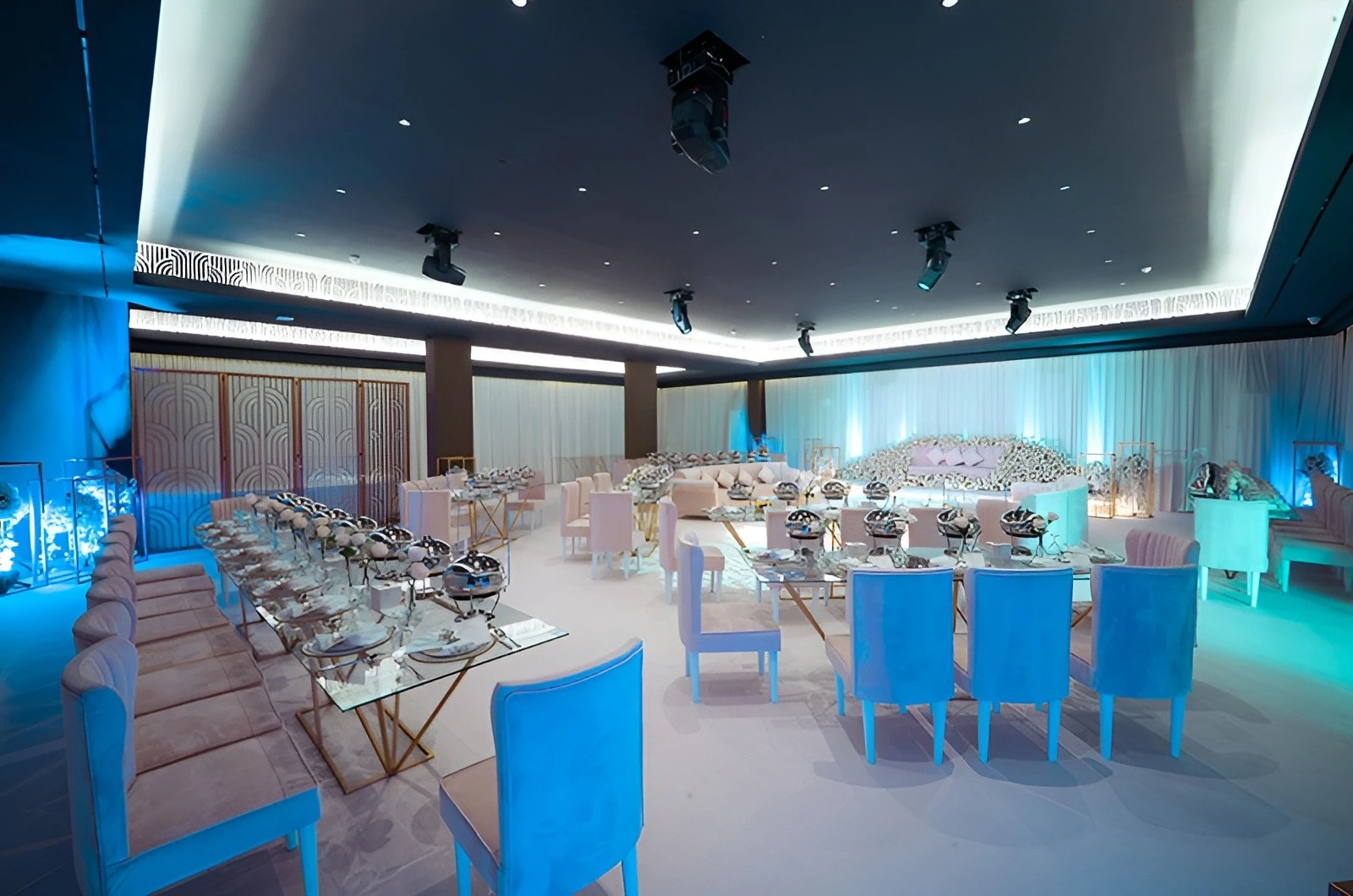 Elegant event setup at U Venue Doha with blue lighting.