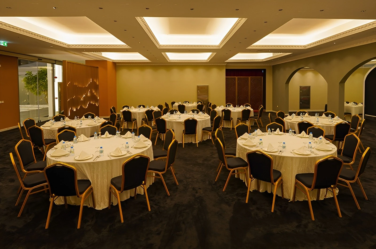 Elegant banquet setup at U Venue Doha with round tables.