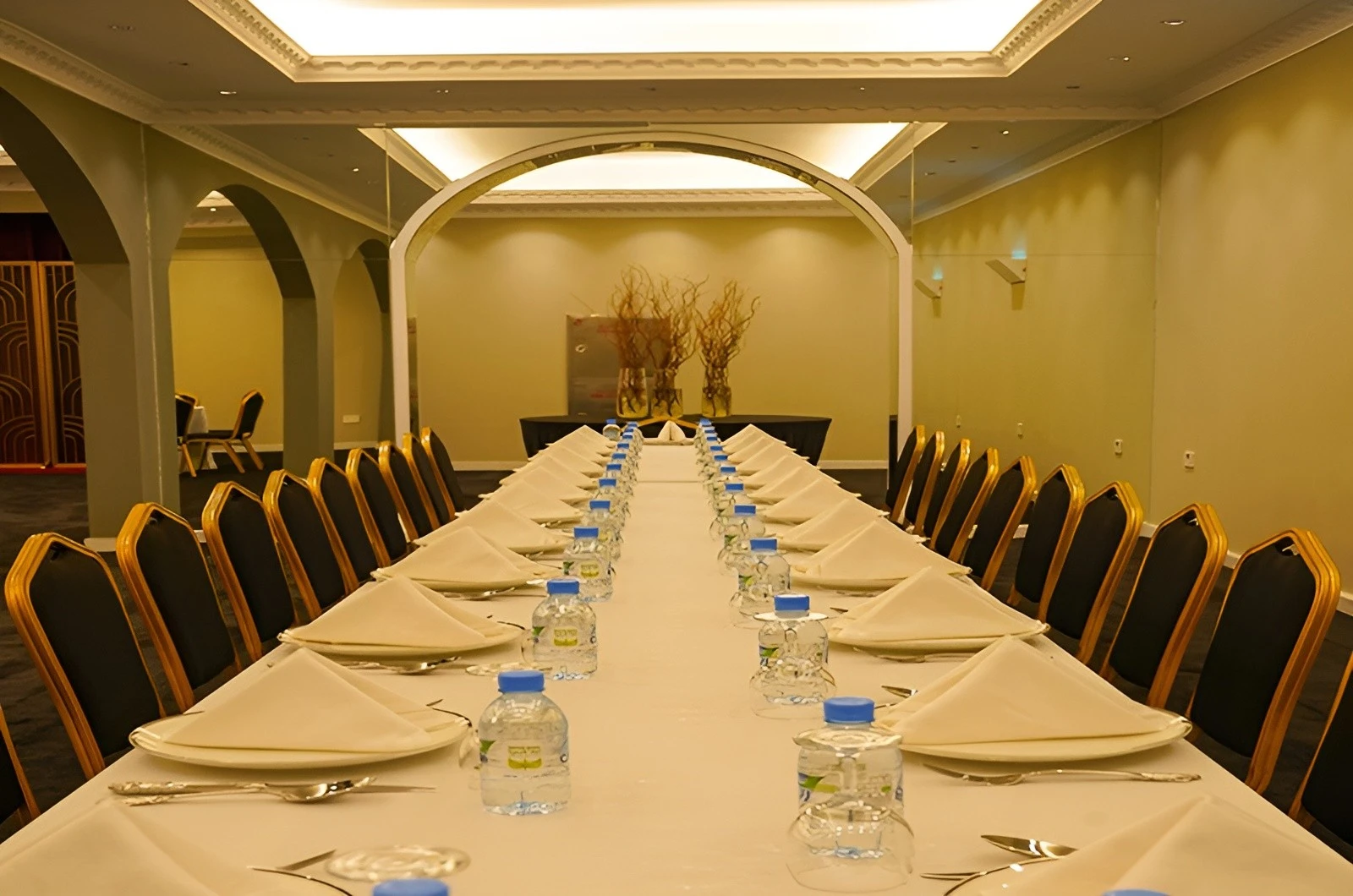 Elegant dining setup at U Venue Doha with long table and chairs.