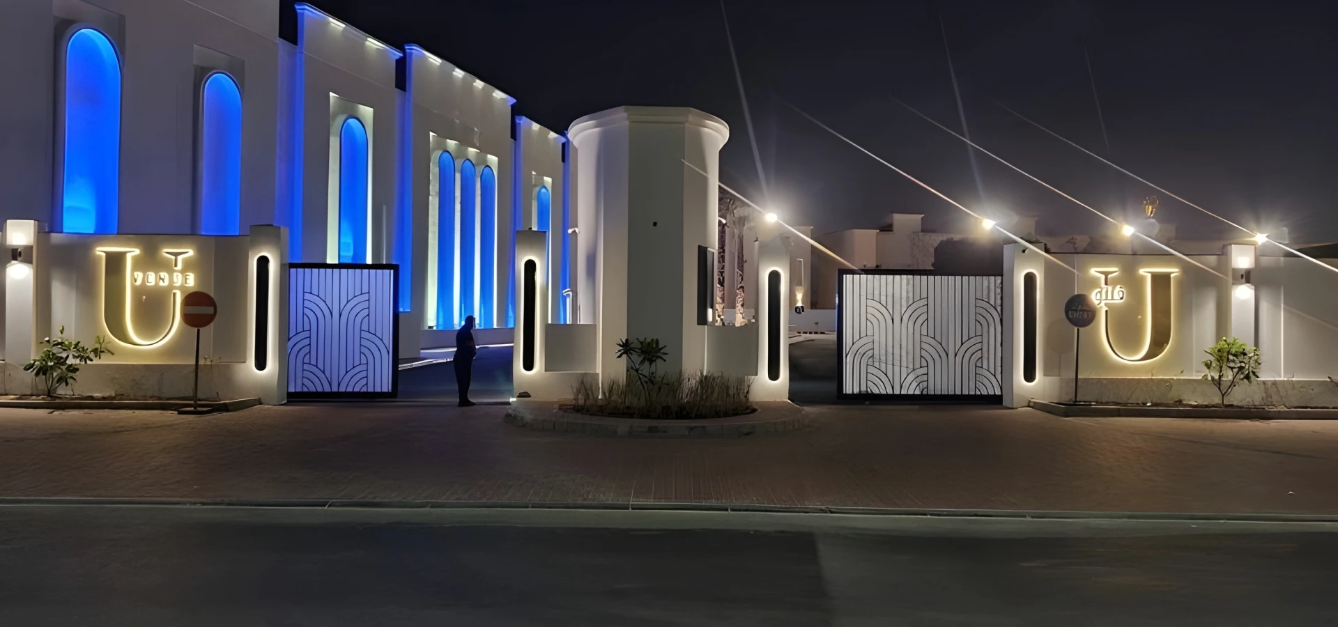 U Venue Doha entrance illuminated at night with blue lights.