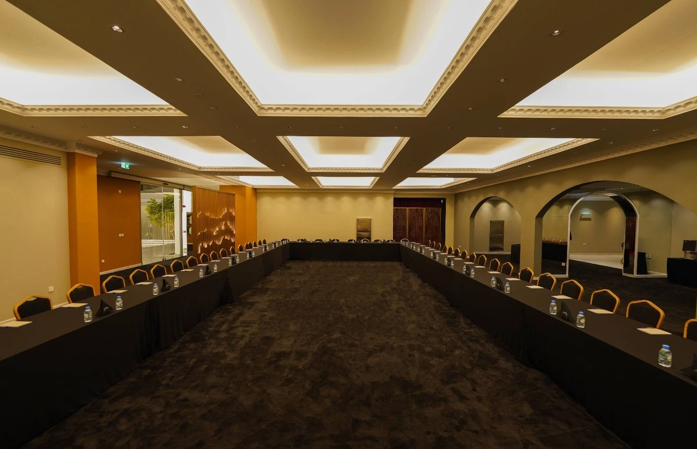 Elegant conference room at U Venue Doha with long tables.