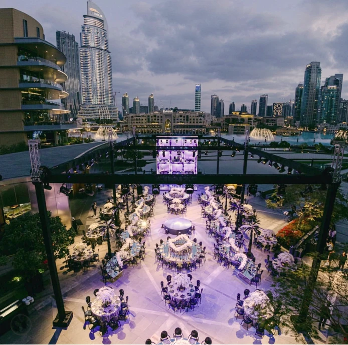 Elegant outdoor event at Armani Hotel Dubai, Burj Khalifa view.