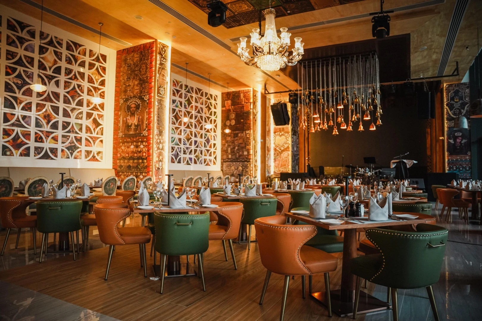 Elegant dining area at Tanatan Dubai with chandeliers and colorful decor.