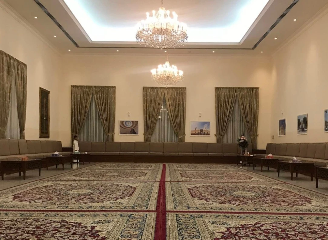 Elegant Fatima Kanoo Hall with chandeliers and patterned carpets, Manama.