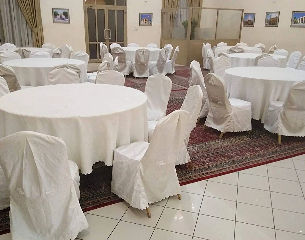 Fatima Kanoo Hall in Manama, elegant tables with white covers.