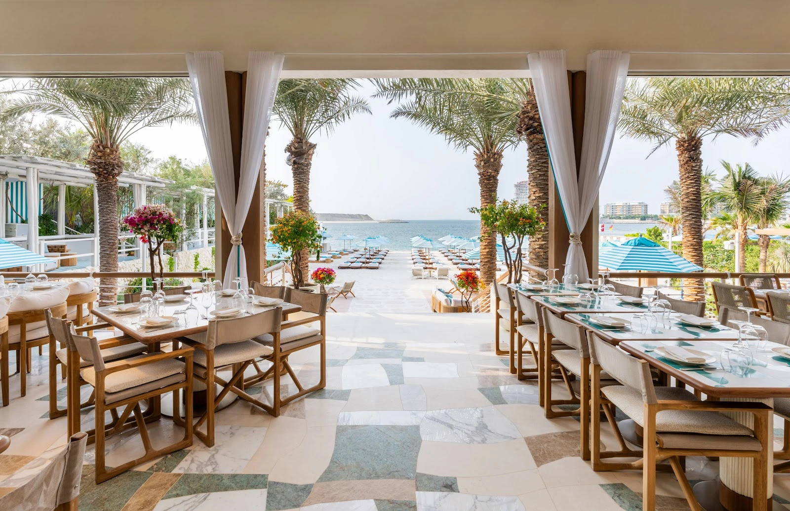 Elegant beachfront dining area at Nammos Dubai with sea view.