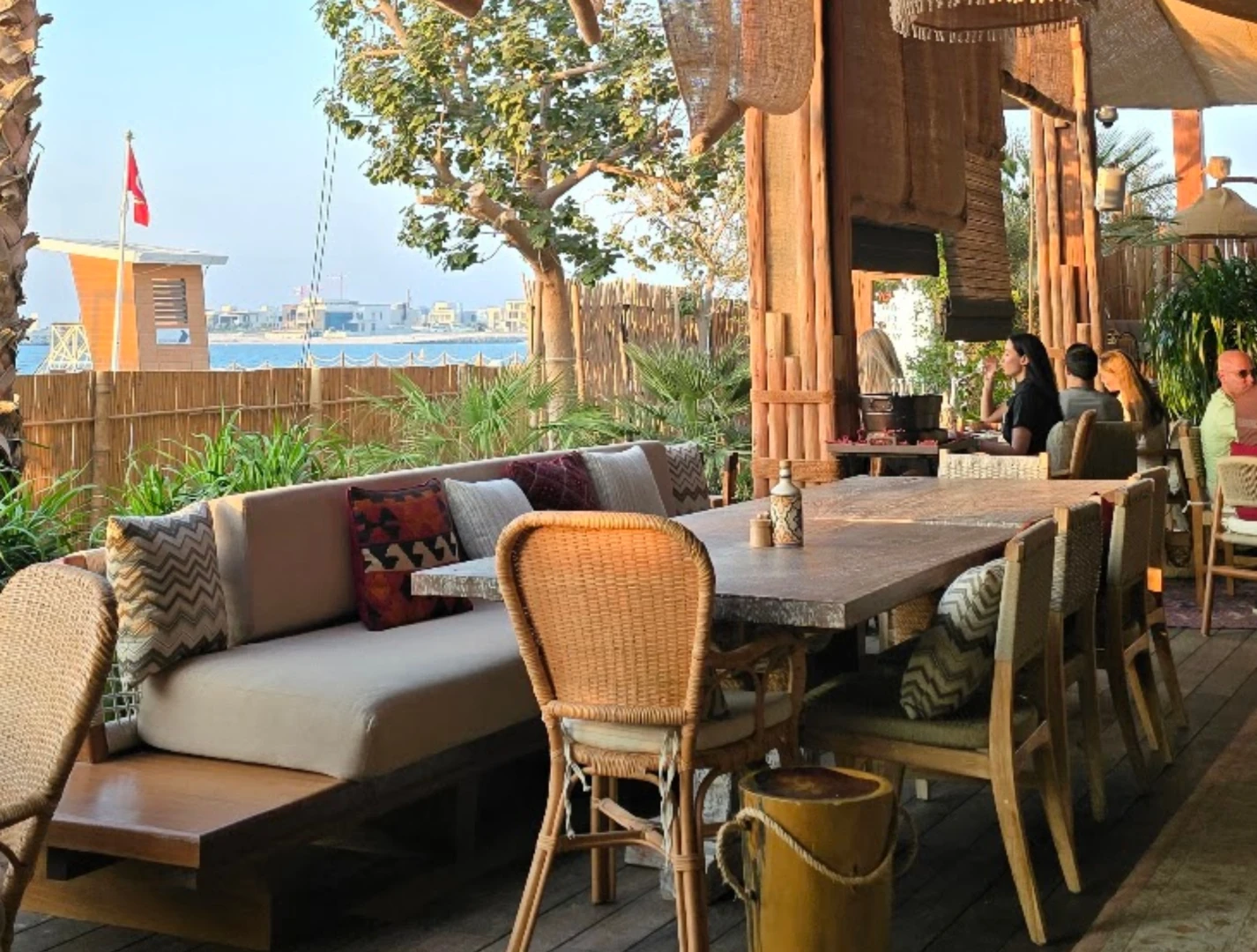 Casa Amor Dubai outdoor seating with ocean view and decor.