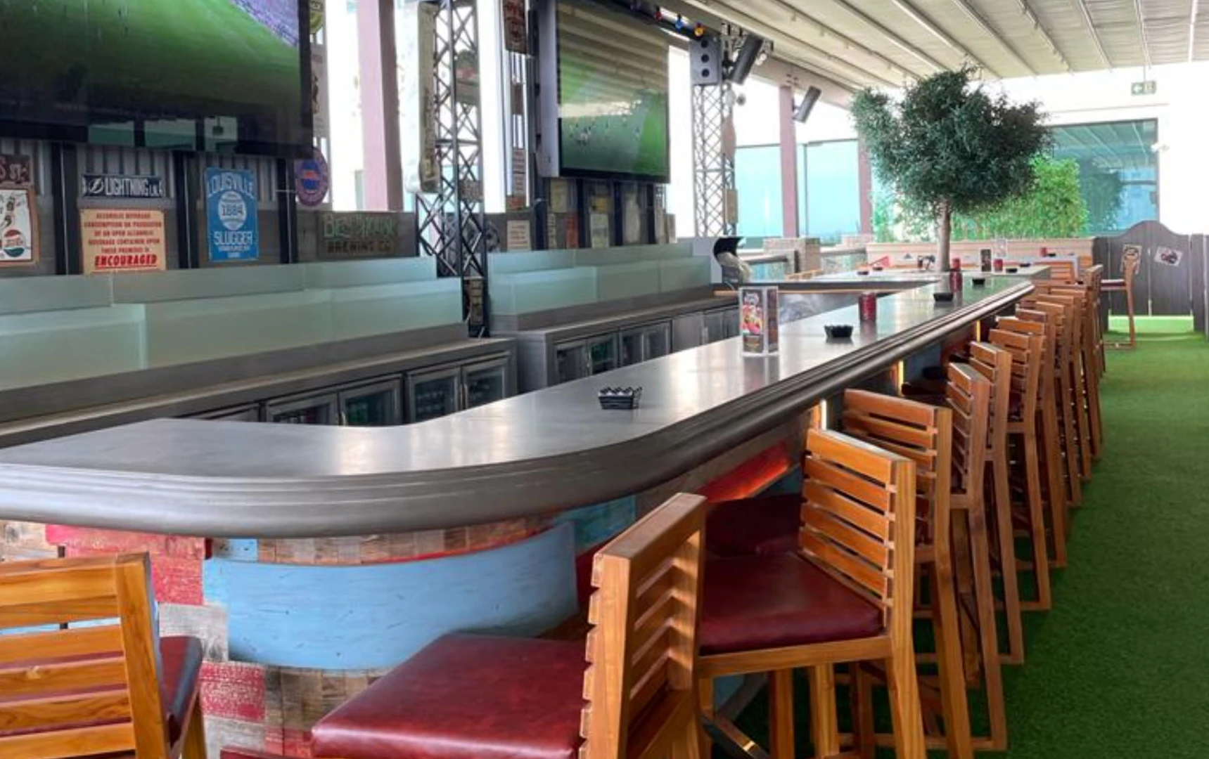 CLAW BBQ The Palm interior bar area with wooden stools, Dubai.