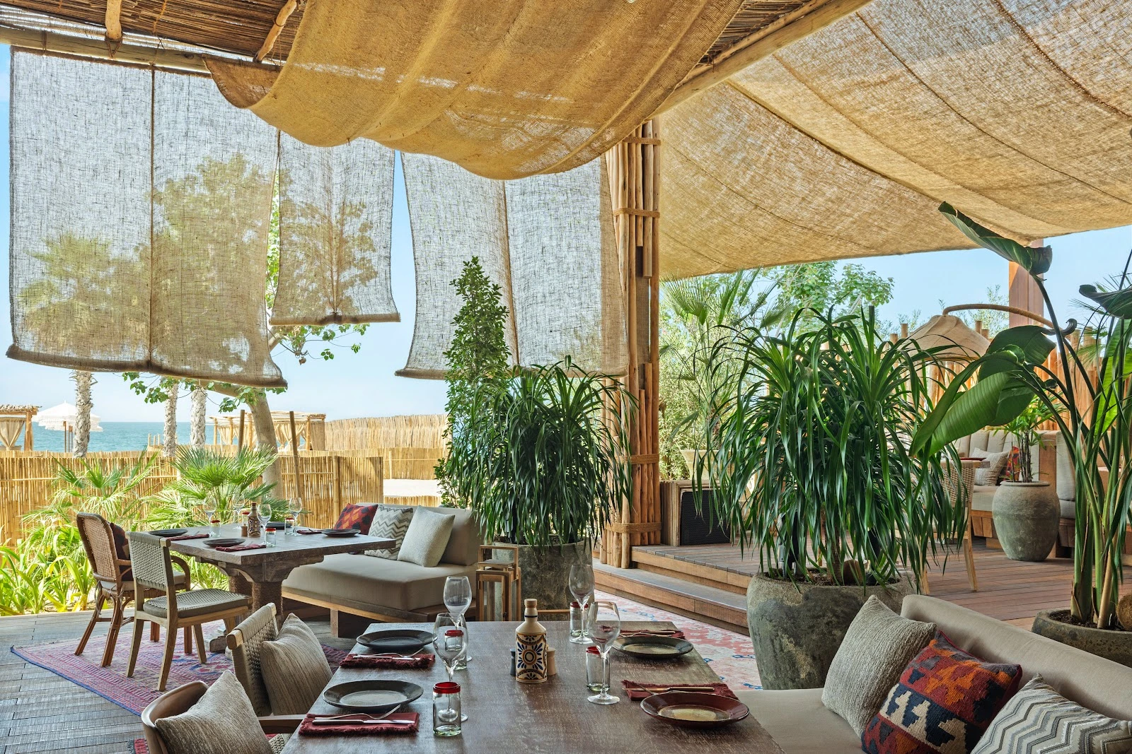 Casa Amor Dubai interior with lush plants and ocean view.