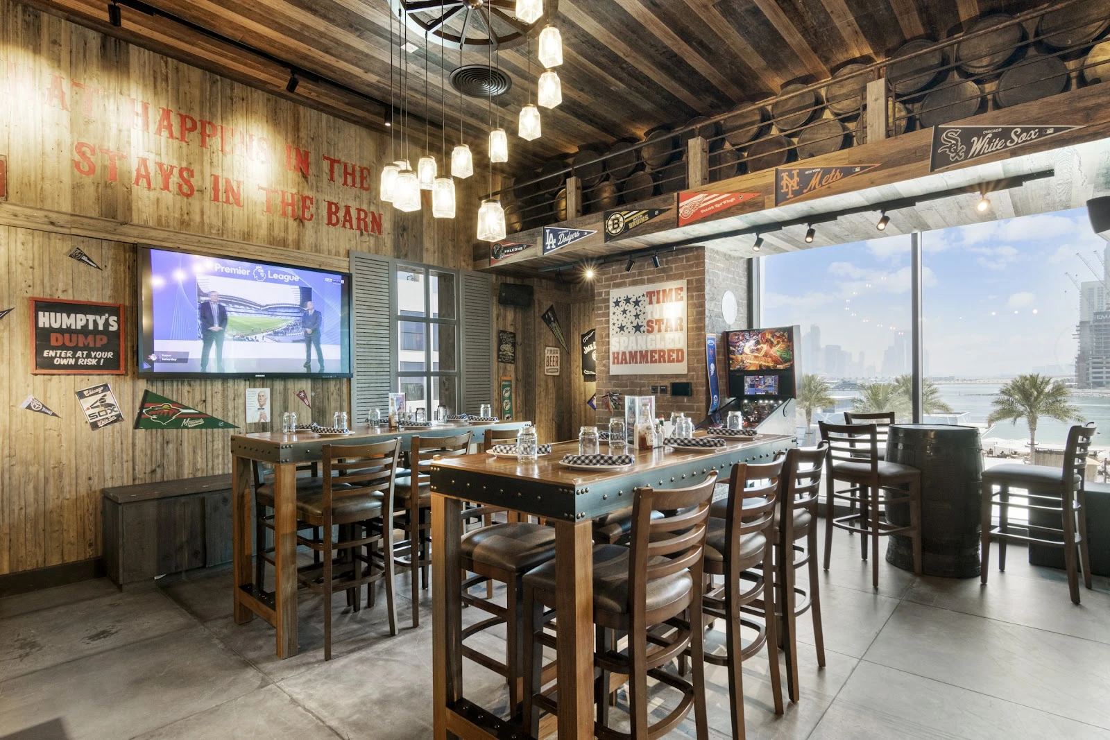Rustic interior of CLAW BBQ The Palm, Dubai with city view.