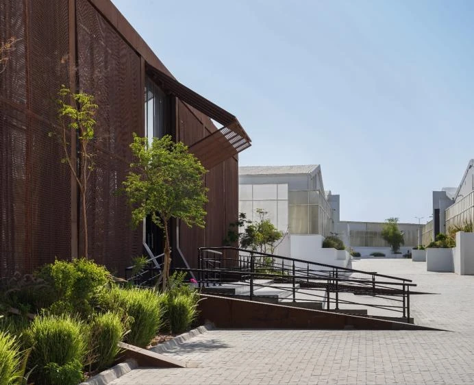 Jax District Riyadh exterior with modern architecture and greenery, Dubai.
