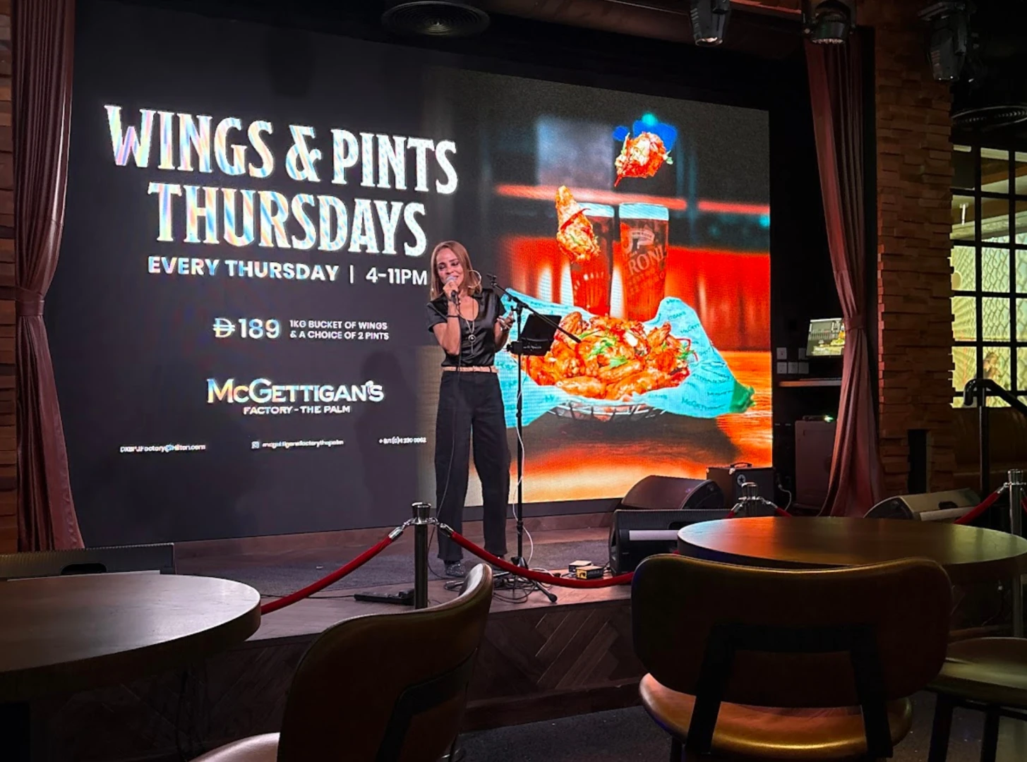 McGettigan's Factory The Palm stage with performer and event screen.