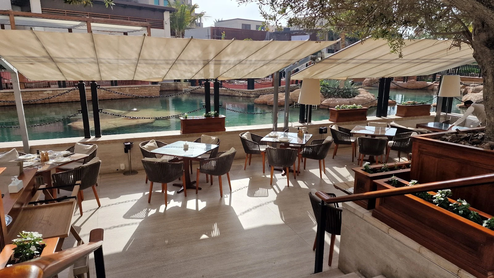 Outdoor seating at Il Borro Tuscan Bistro Dubai by water.