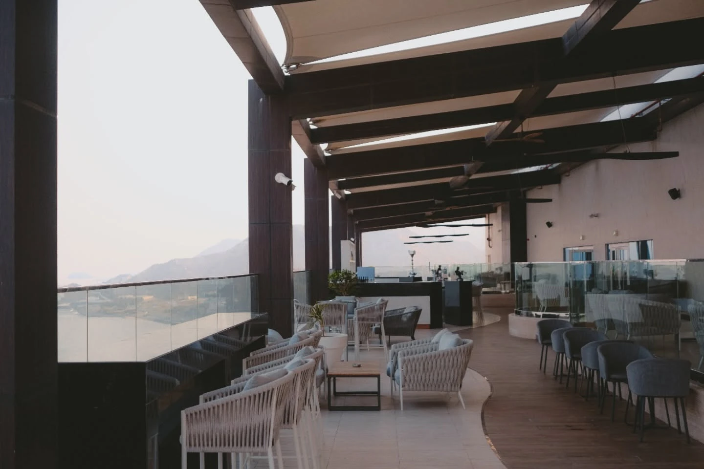 Elegant terrace at Royal M Hotel, Dubai, with mountain views.