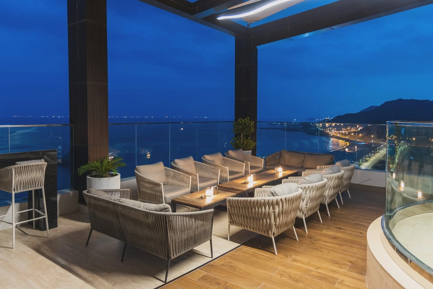 Elegant rooftop seating at Royal M Hotel, Dubai, overlooking the sea.