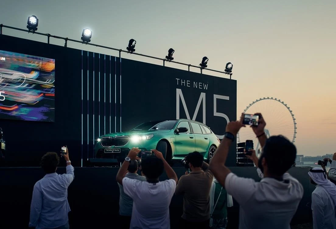 Car launch event at Skydive Dubai, Dubai, UAE with audience capturing photos.