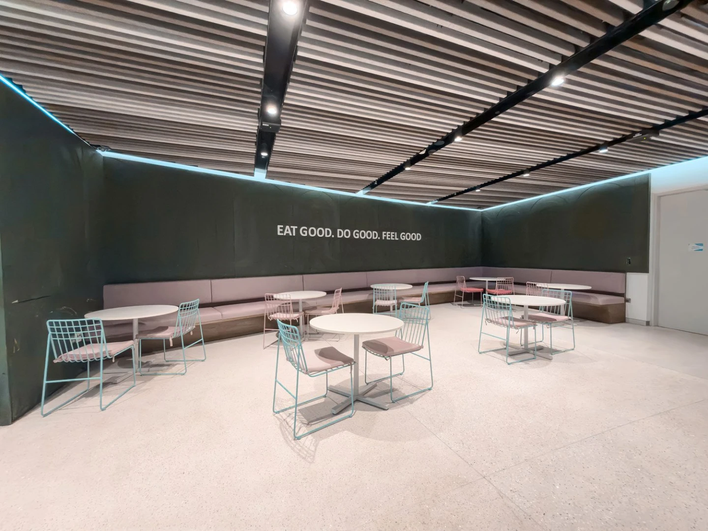 Modern seating area with round tables at Terra, Expo City Dubai, UAE.