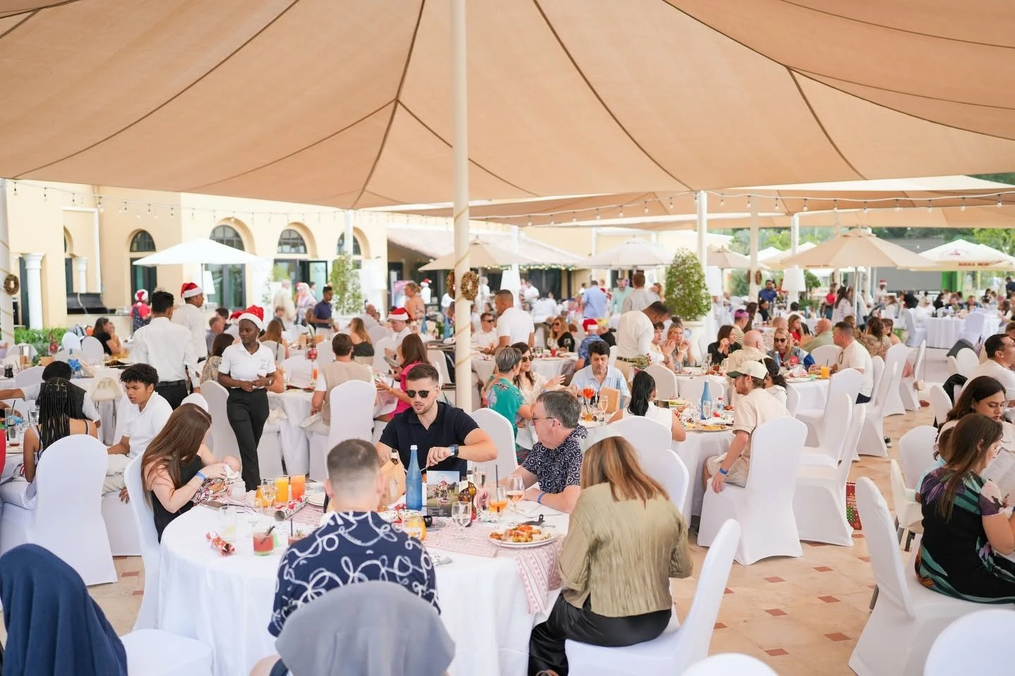 Guests dining under canopy at Dubai Polo & Equestrian Club, Dubai, UAE