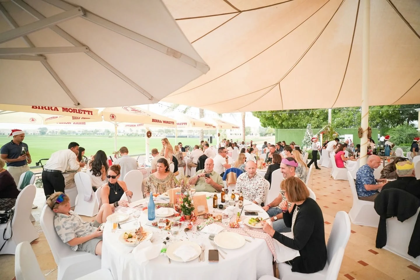 Guests dining under canopies at Dubai Polo & Equestrian Club, Dubai, UAE