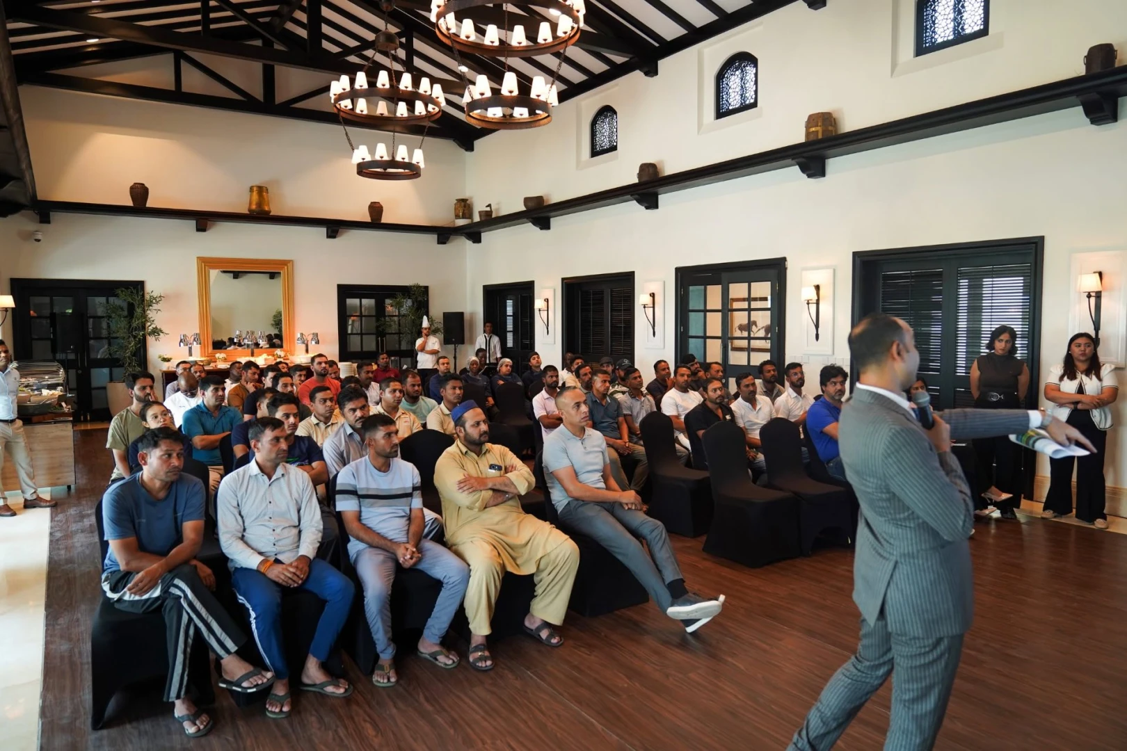 Speaker addressing audience at Dubai Polo & Equestrian Club, Dubai, UAE.